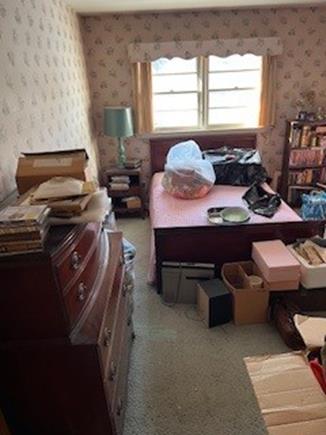 Bedroom after a sort and organize session to clear out items for auction and donation 